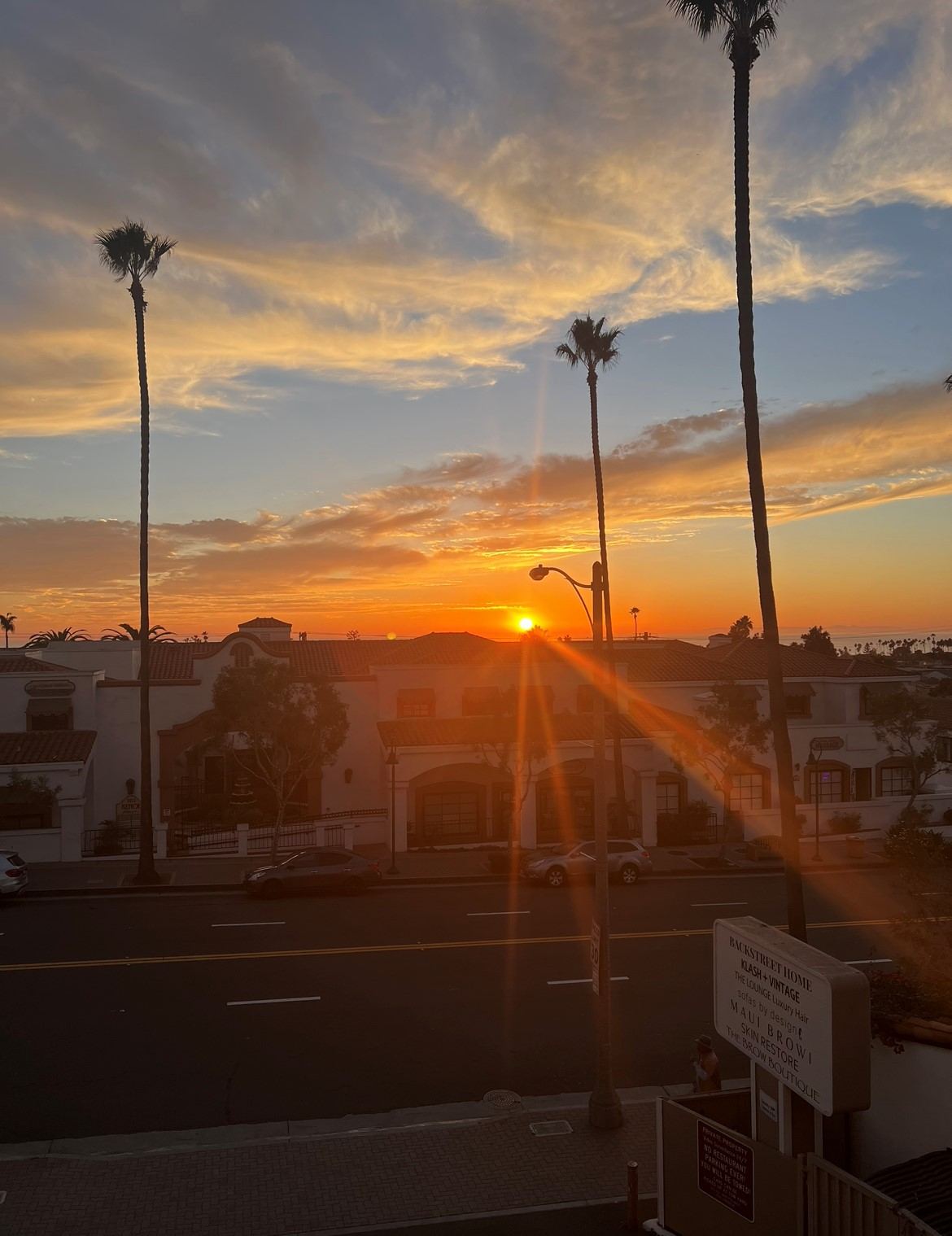 Avenida de la Estrella at sunset in San Clemente, with the Skin Restore sign